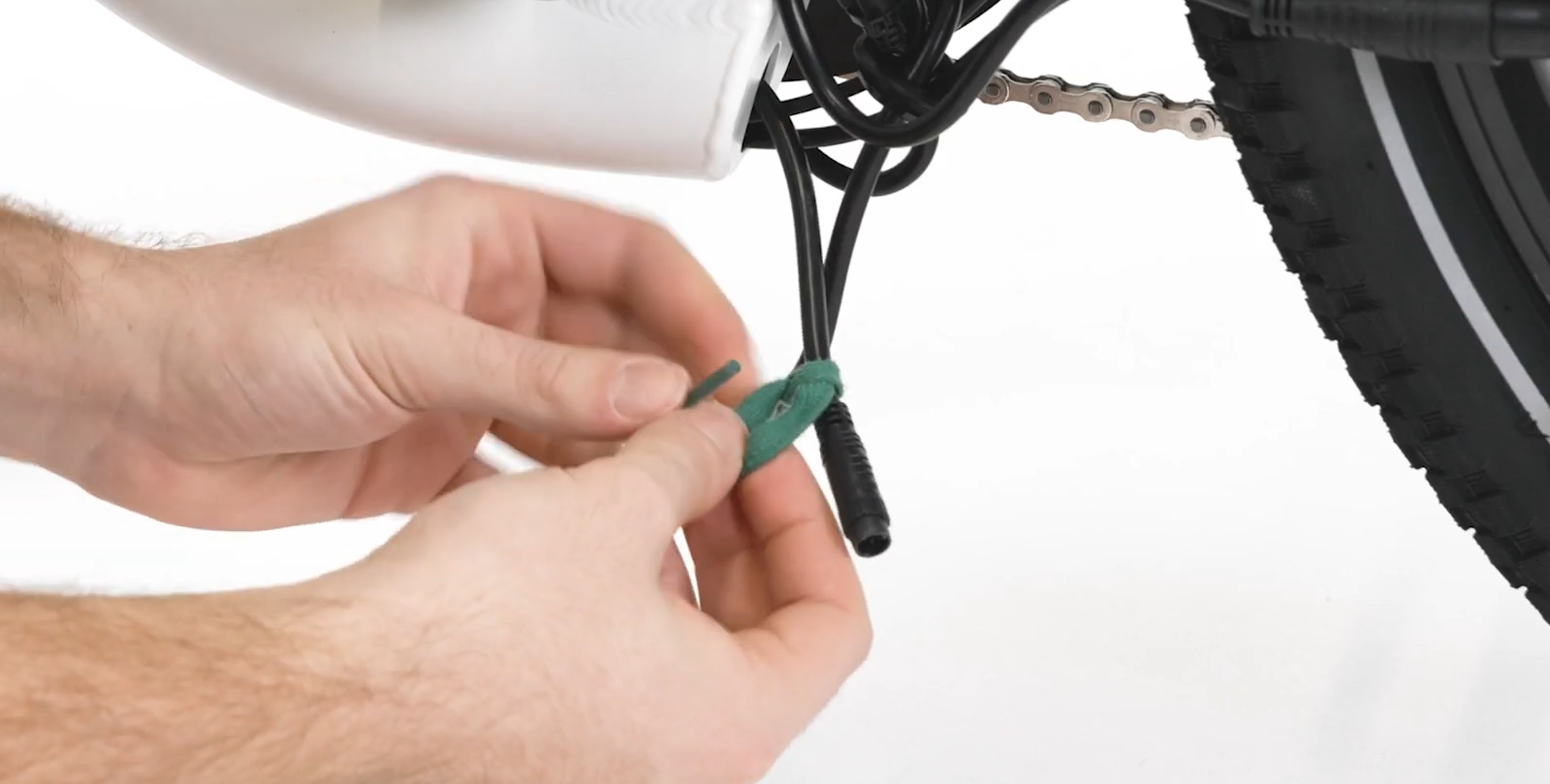 tie string to lower cable opening connector.png