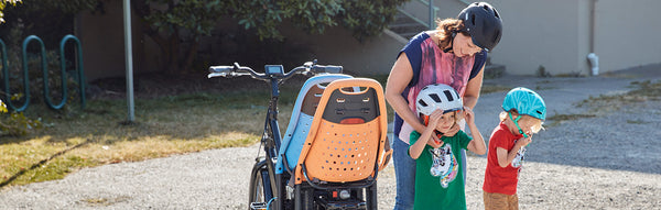 A woman gets two kids ready alongside her RadWagon