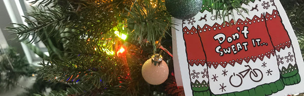 A Rad Power Bikes holiday sweater card perched on a Christmas tree.