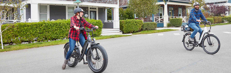 A man and woman on a suburban street with their RadCity 5 Plus and RadRover 6 Plus.