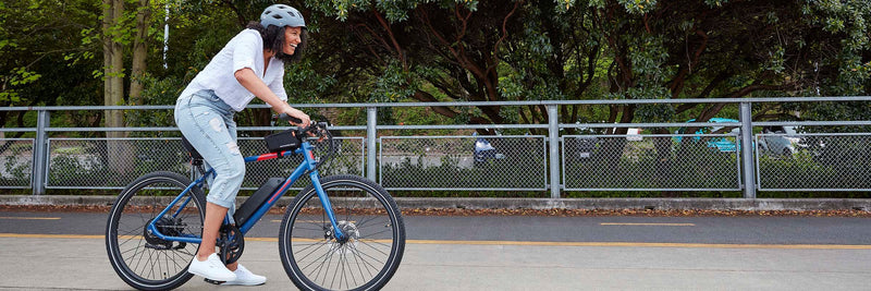 Woman smiles while riding her Rad Power Bike RadMission ebike.