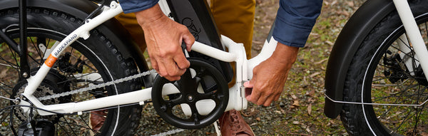 Man adjusts his folding ebike.