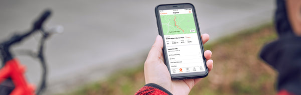 A Rad Power Bikes rider looks at a map of his route on his phone.