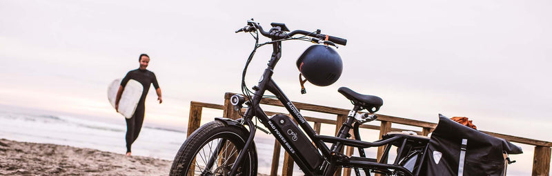 Man walks from the ocean to his RadWagon 4 ebike.