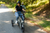 Two people in helmets ride RadTrike electric tricycles on a path.