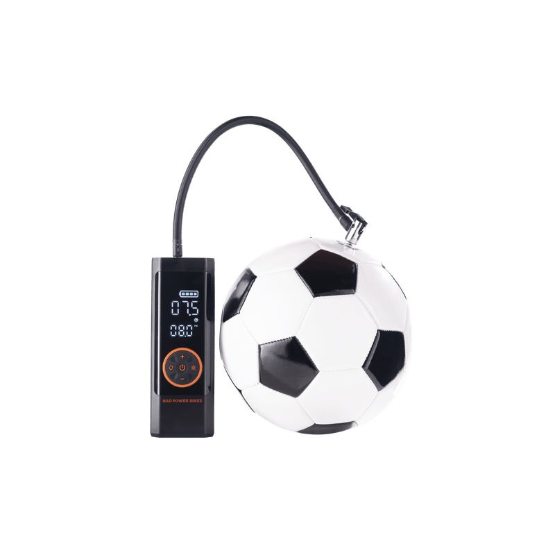 Rad Portable Tire Inflator automatically inflating a black and white soccer ball. 