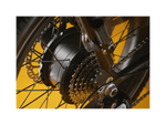 Black ebike motor and chains on a black wheel. 