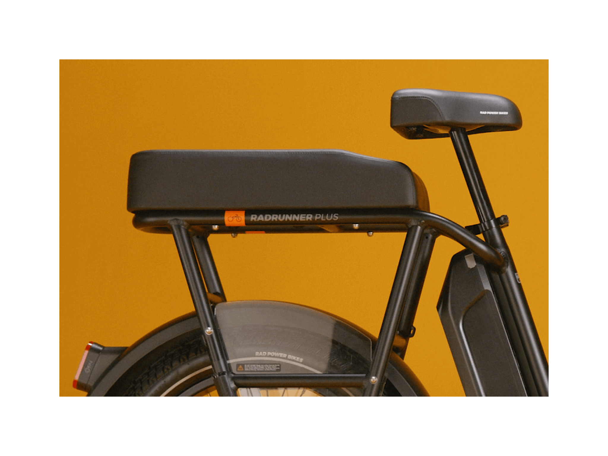 Black passenger seat on a black electric cargo bike. 