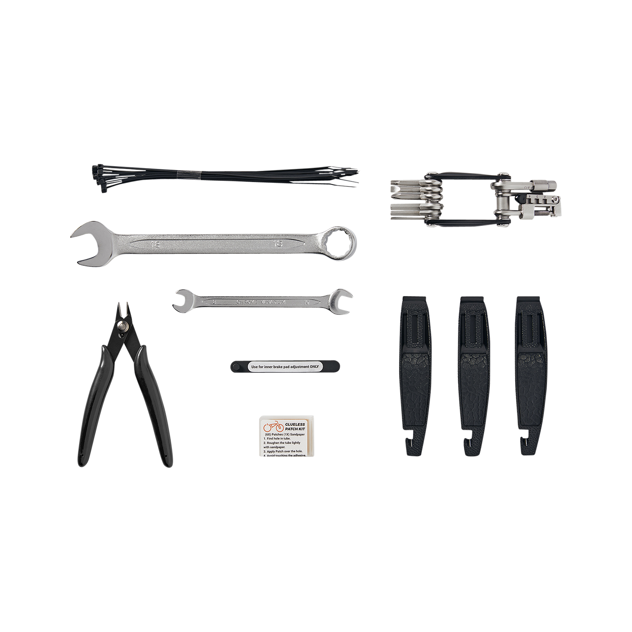 Detailed view of the tools included in the Roadside Repair Tool Kit: 18 mm Wrench, 8 / 10 mm Wrench, Flat-side Cutters, Brake Inner Pad Adjustment Tools, 3 Tire Levers, Glueless Patch Kit, and a Multi-tool featuring a #2 Philips Head Screwdriver, Flathead Screwdriver, Six Allen Wrenches, T25 Torx Wrench, Chain Tool, and Custom Rad Spoke Wrench. 