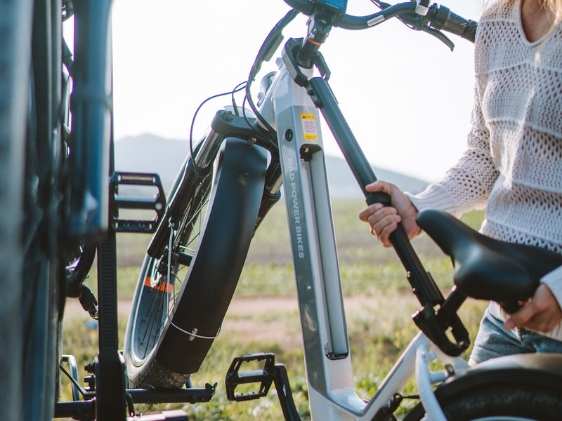 A person uses a Bike Adapter Bar to attach an ebike to an RV rear rack