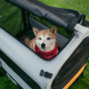 Rad Trailer Pet Insert on the grass in a park with a dog inside, with the back panel unzipped.