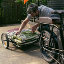 Rad Trailer attached to an electric bike with the pet insert attached and a cute dog inside the pet carrier.